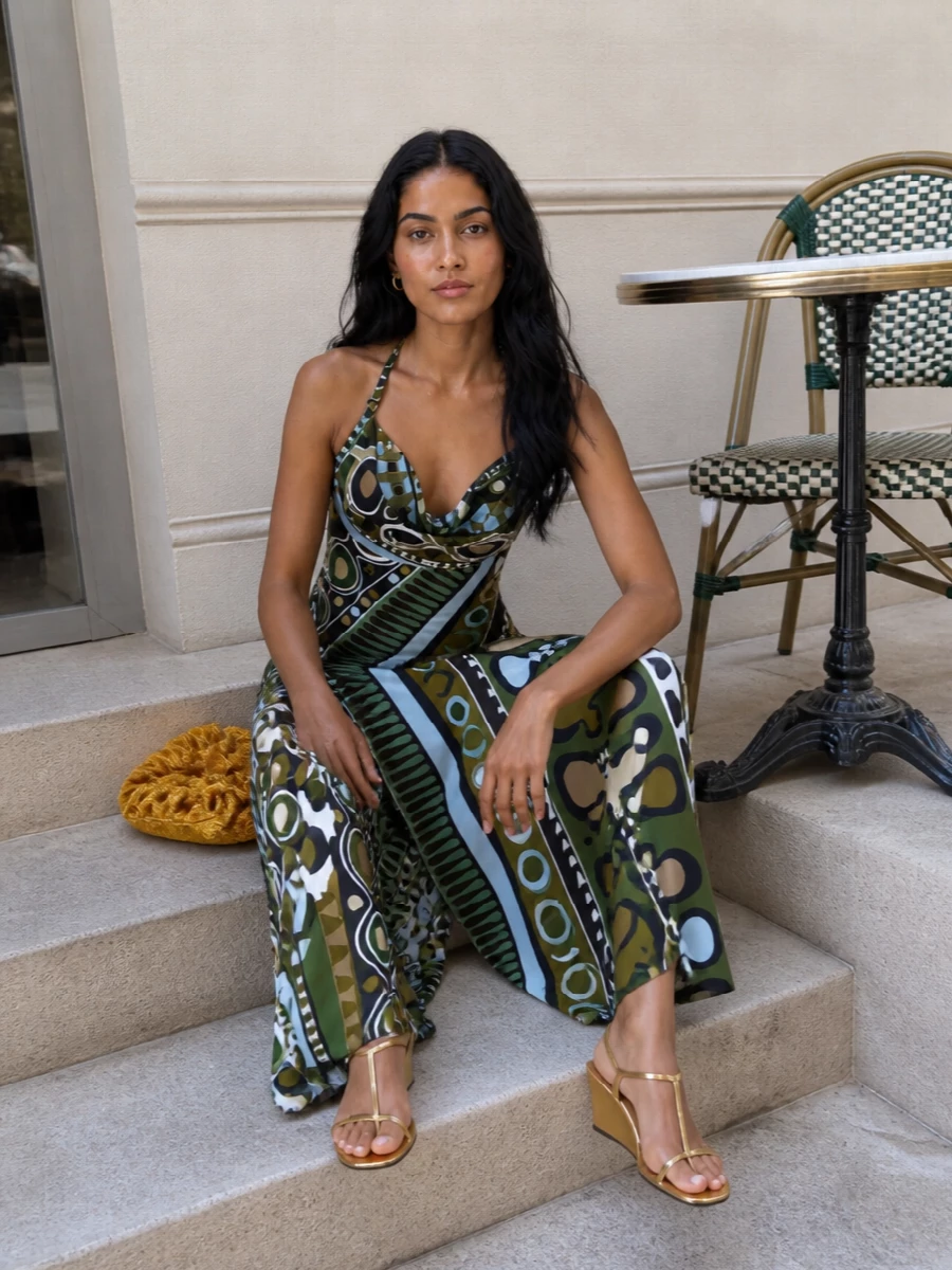 Pucci’s liquid halter dress meets a clean hit of gold for a retro-glam summer night. The metallic wedge keeps the print grounded yet party ready, while the sculptural clutch brings a subtle, sunlit shimmer. It is poolside cocktails turning into late terrace hours, with the print doing the talking and the accessories just catching the light.