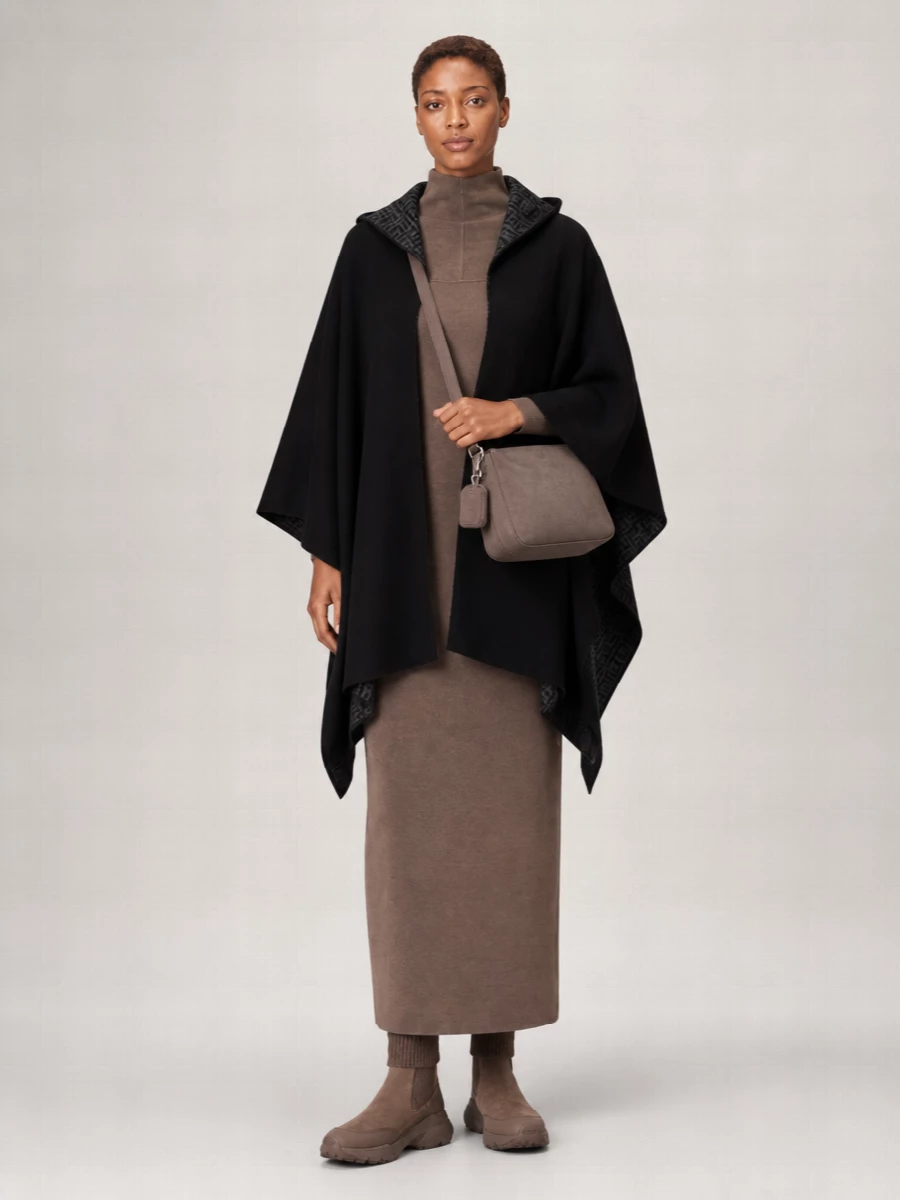 I’m styling the Fendi poncho over a long, body-skimming Max Mara knit dress rather than top and trousers, so the drama of the cape reads as one continuous, sculpted line. Tod’s sock-sneaker boots keep it grounded and walkable in the city, while Armani’s taupe crossbody whispers polish in the same low-contrast neutrals. The result is a quietly luxurious winter column that feels cocooning but very intentional rather than loungey.