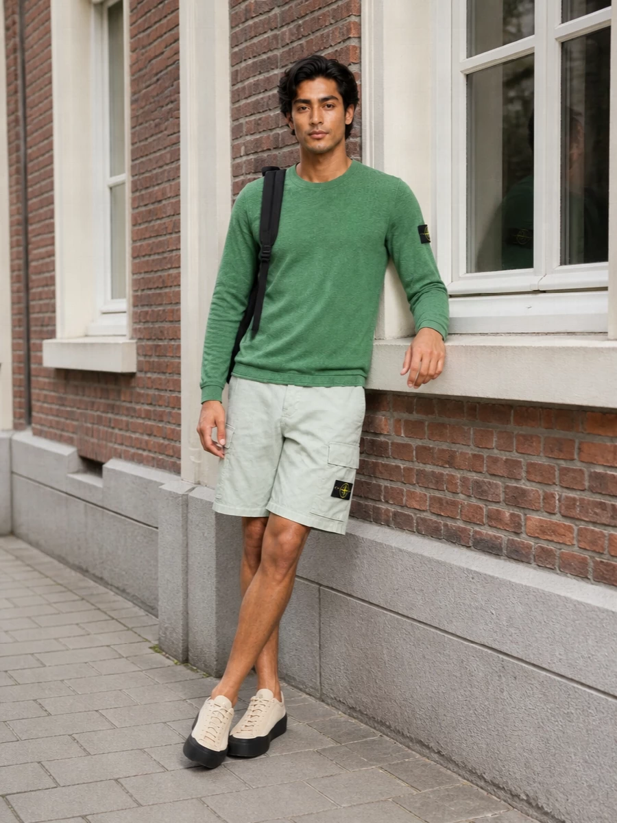 Heathered green on top and washed sage on the leg create a tight tonal story that feels fresh but still grounded in Stone Island’s utility DNA. The technical low-top in soft neutrals and a clean black backpack keep the silhouette streamlined and practical, perfect for city days where comfort and quiet detail matter. It is an easy, modern street-sport mix that reads intentional without feeling overthought.