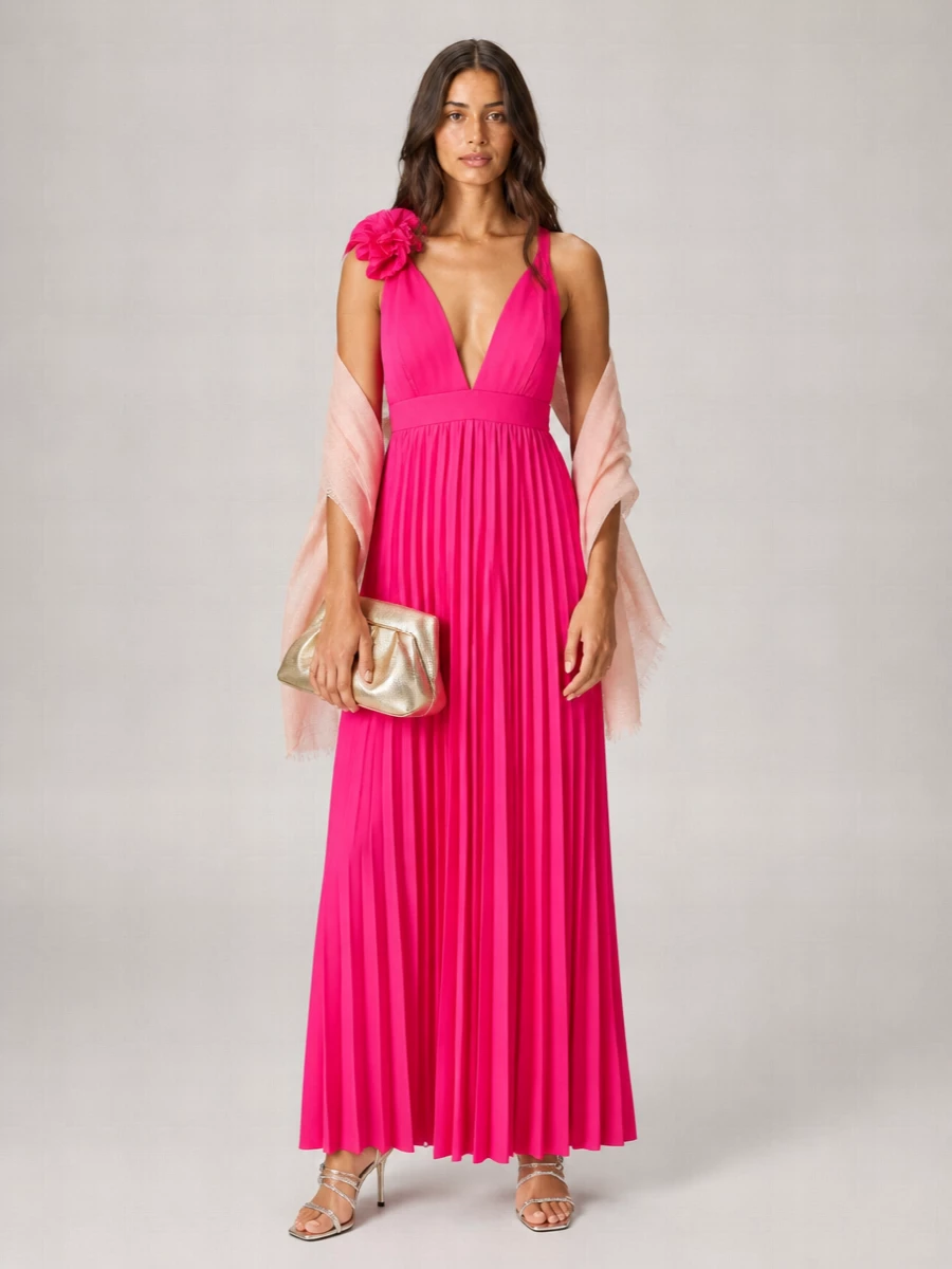 A vivid Parosh maxi is grounded with gleaming metallic accessories for a modern, photo-ready evening ensemble. Silver sandals and a sculpted gold clutch catch the light while a blush stole softens the plunging neckline and feels elegant over bare shoulders. The result is romantic, polished and ideal for summer weddings, terraces or destination parties where you want color to lead with refinement around it.