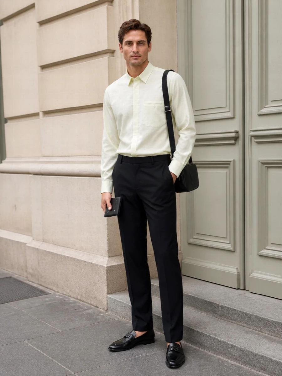 A pale butter pleated shirt softens the rigor of sharp black tailoring, echoing the Margiela wallet’s quiet confidence without competing with it. Sleek loafers and a discreet Gucci crossbody keep the silhouette clean and city-ready, all in a restrained palette that moves easily from gallery afternoons to low-key dinners. This is modern, minimal menswear that signals discernment through cut, texture, and proportion rather than visible logos.