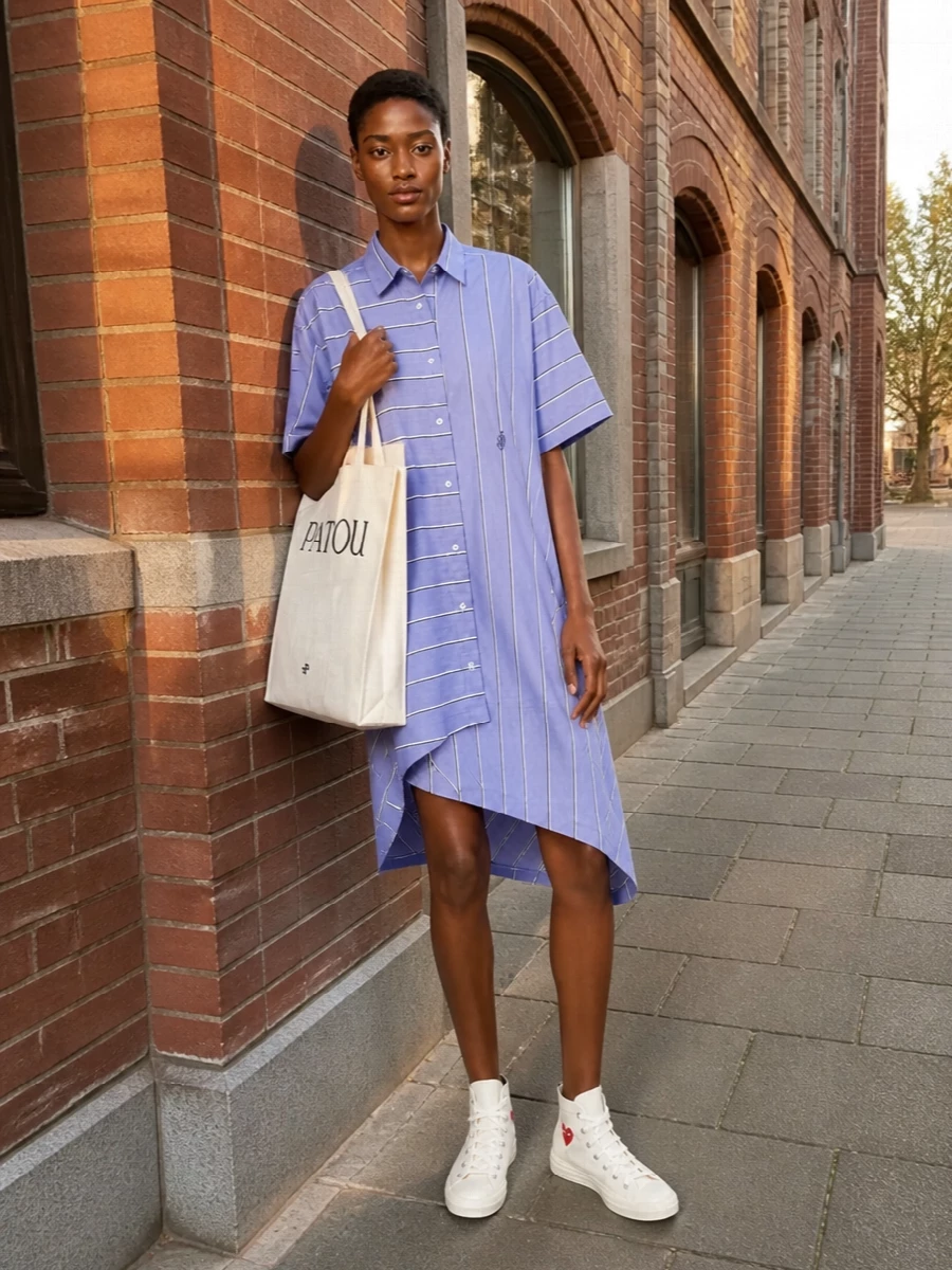 The Comme des Garçons high-tops and JW Anderson striped shirt dress lean into a clean, slightly offbeat preppy mood that still feels relaxed and easy. The crisp shirting, asymmetric hem and graphic sneakers keep the palette tight and the attitude playful, while the Patou tote adds just enough logo contrast to read polished for all-day city wear.