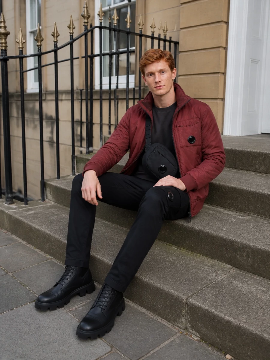 Cp company red jacket black cargo pants outfit