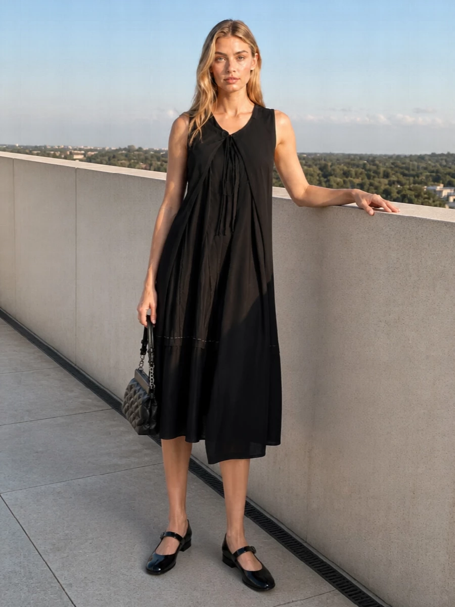 This pairing leans into a monochrome Margiela evening mood: the asymmetric black cocktail dress echoes the Tabi Mary Janes’ sculptural line while keeping the overall effect clean and restrained. Choosing a dress over tailoring keeps the silhouette long and uninterrupted so the split-toe flats feel intentional rather than casual. The compact quilted bag finishes it with a discreet after-dark texture that stays firmly in the minimalist, quiet-luxury space.
