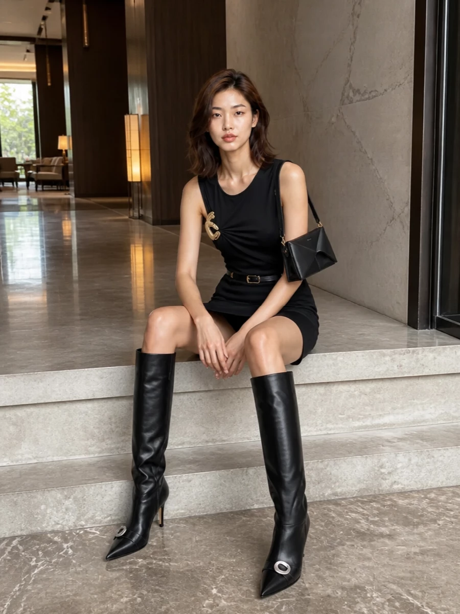 Coperni black mini dress knee high boots outfit