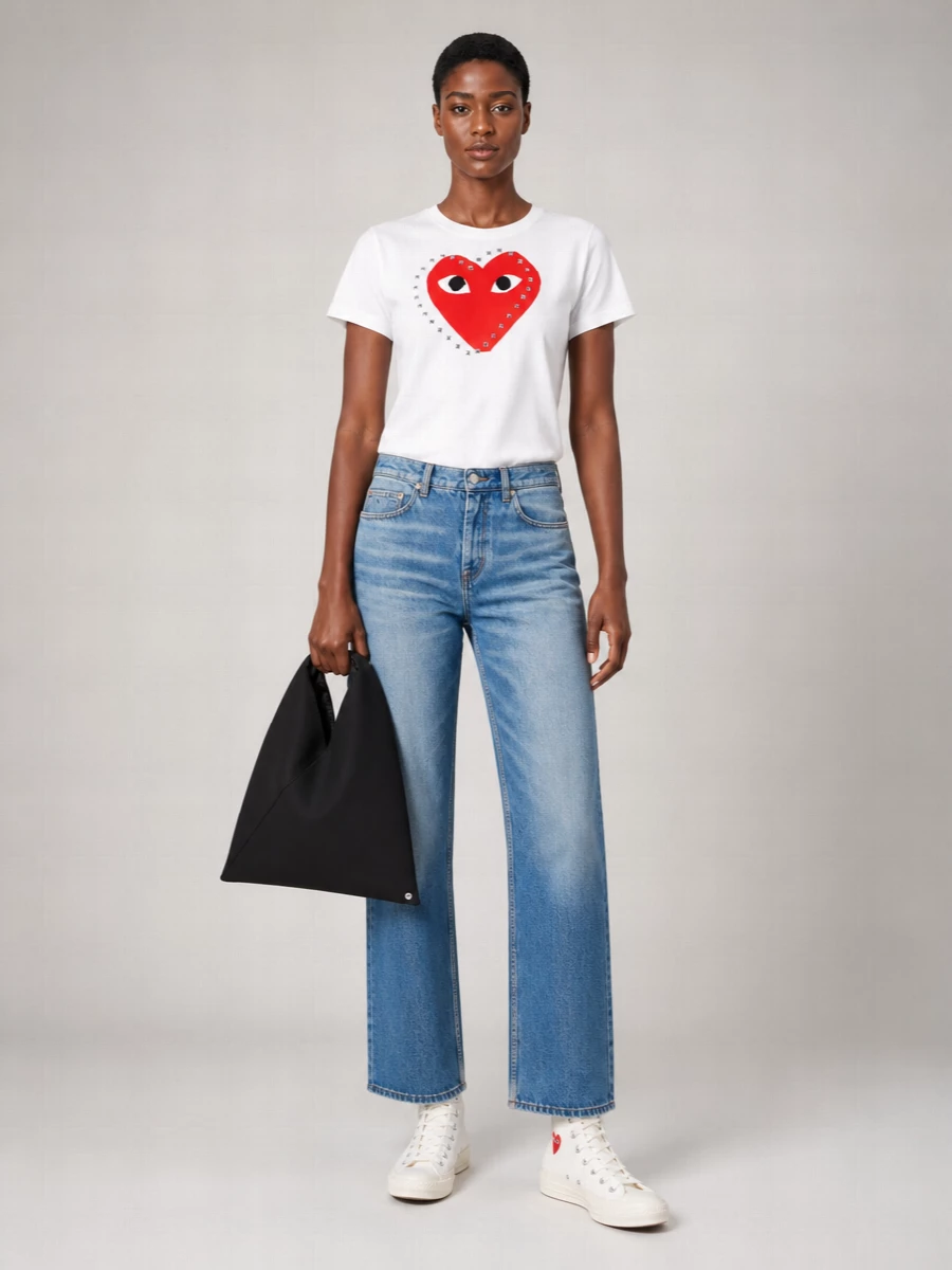 This is a graphic, heart-driven streetwear pairing that leans into the Comme des Garçons Play story without feeling costume-y. The crisp white tee and mid-blue straight jeans let the sneakers’ red heart pop, while the angular black tote adds a sharper, more grown-up contrast. I chose the tee-and-denim route over a dress to keep it closer to the sneaker’s skate-preppy DNA and give you an everyday uniform you will actually reach for on repeat.