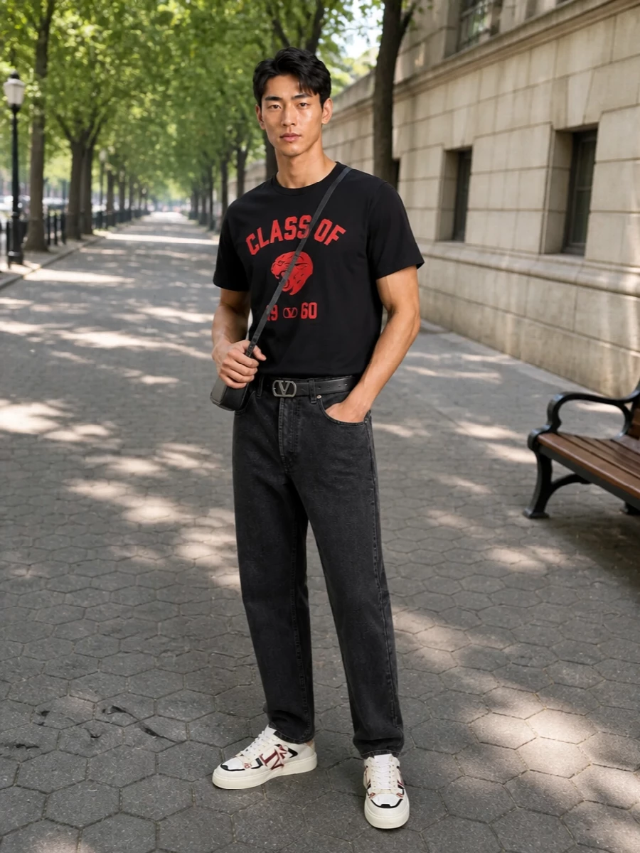 A graphic Valentino tee sits against washed charcoal denim, keeping the red and black story tight and a touch subversive rather than nostalgic. Off-white court-inspired sneakers lighten the base, while a compact black crossbody and clean VLogo belt bring just enough metal to feel considered without competing with the panther graphic. The result is luxury collegiate streetwear that feels polished but still easy for real life.