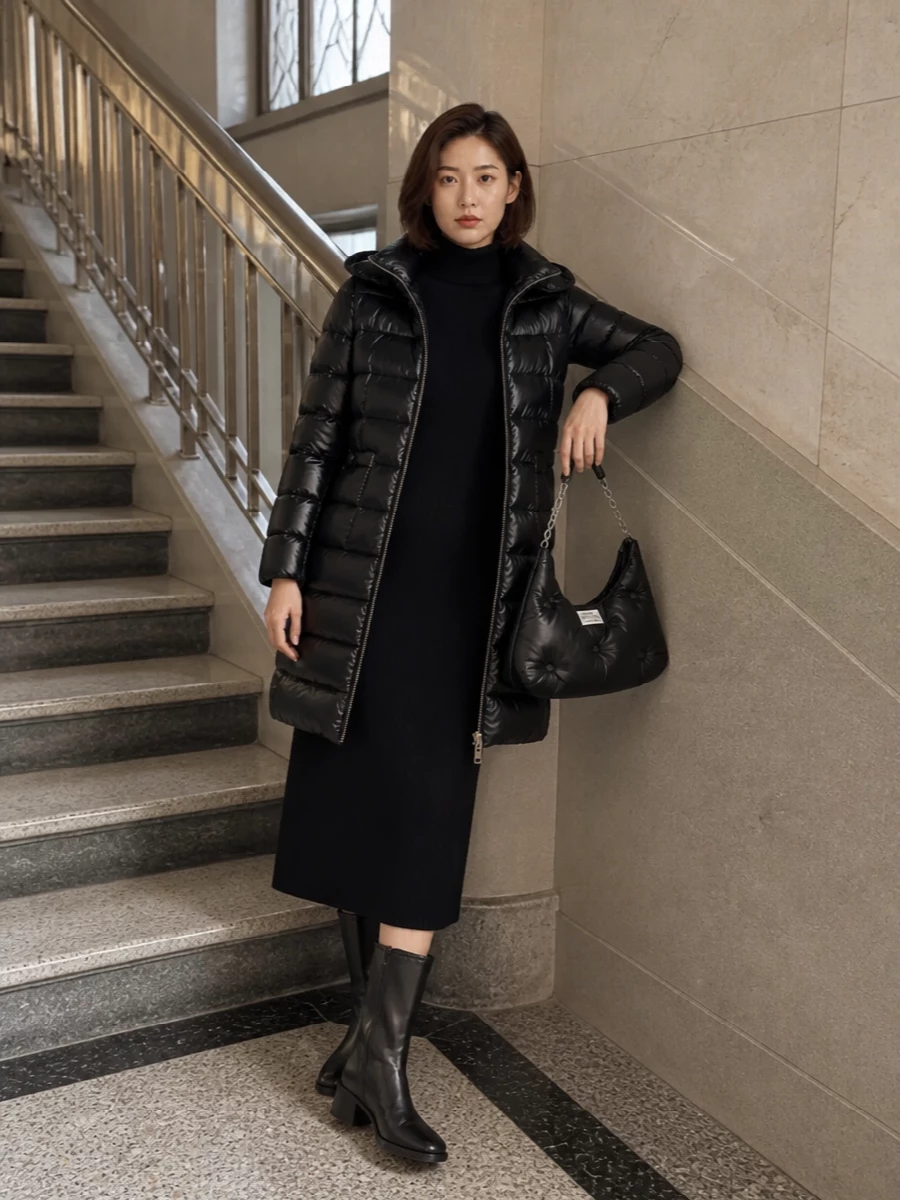 A single black knit column under the glossy Herno puffer keeps the mood quiet and elongated, so the texture of the coat and bag can really read. I chose the dress path because it feels more intentional and streamlined with this longline outerwear than breaking the line with a separate top and trouser. Block-heel boots ground it in the city, giving you a winter uniform that moves easily from commute to low-lit dinner.