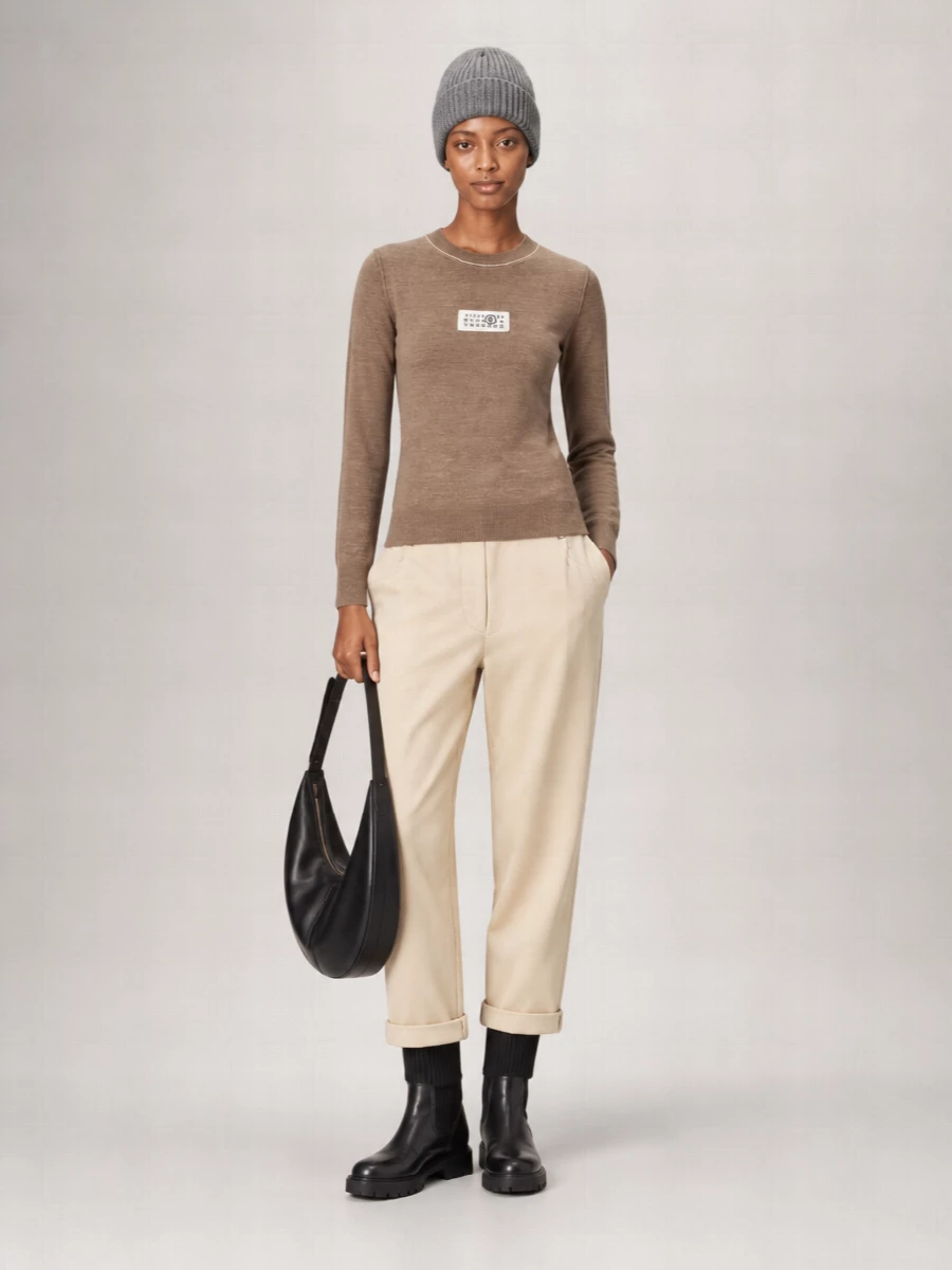 The Fendi ribbed hooded mini and grey Miu Miu beanie create a tight, graphic knit story that leans into minimalist streetwear without losing its quiet polish. Chunky black Gianvito Rossi boots ground the proportions and make the mini feel city-proof, while the black Marni crescent bag keeps the line clean and functional. Choosing the dress route over separates keeps the silhouette sharper and more intentional, with the beanie, boots and bag all reinforcing that streamlined, urban winter mood.