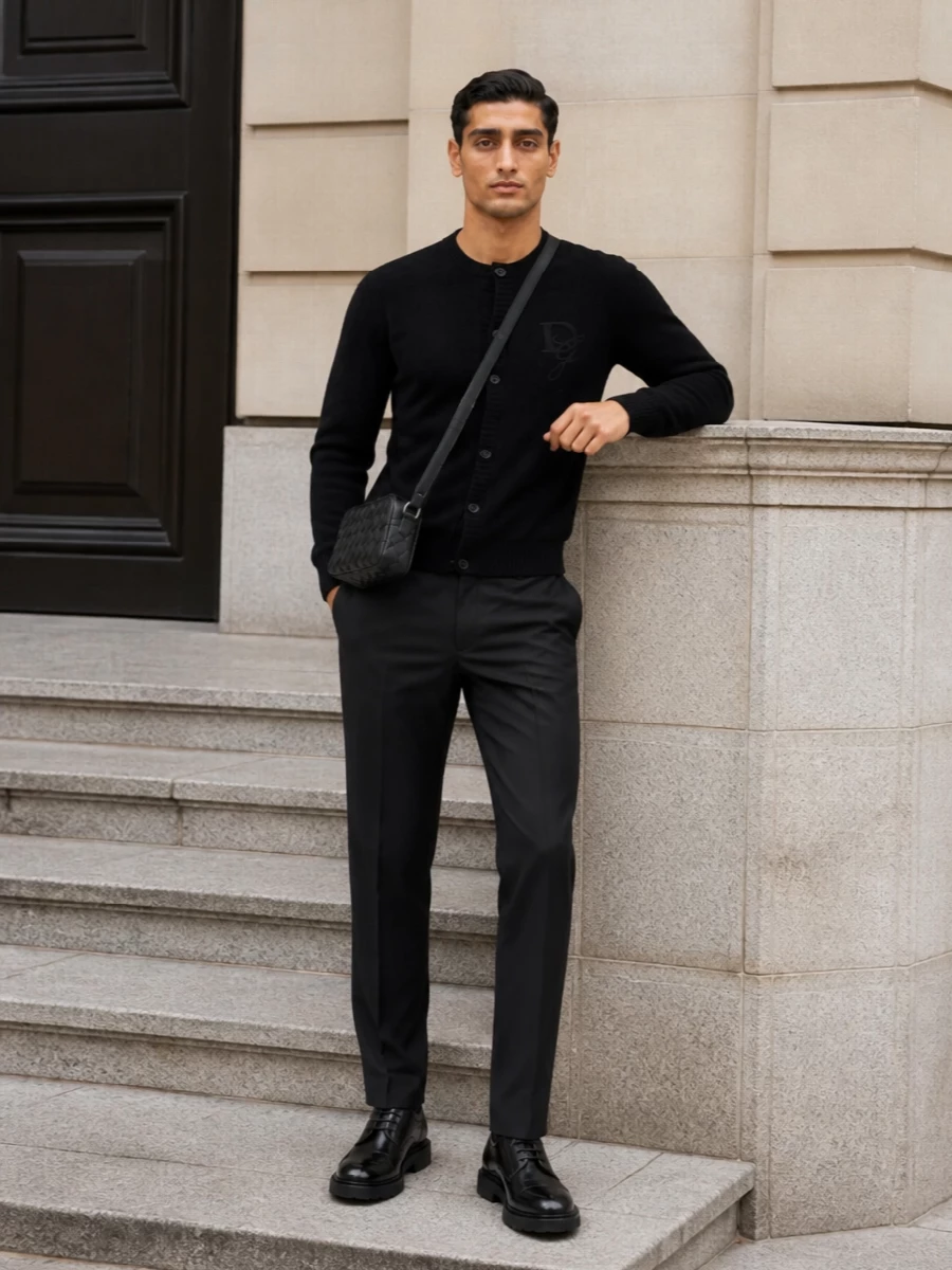 A black Dolce&Gabbana cardigan meets precise charcoal Dior tailoring for a quietly confident city uniform. Bottega’s sculpted derby and intrecciato crossbody introduce texture and a subtle street edge while keeping everything firmly in the luxury lane. The result is a monochrome mix that works from smart office days to low-key dinners without needing to change a piece.