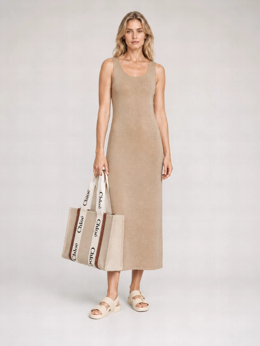A warm beige knit column dress pairs seamlessly with the Chloe canvas tote, keeping the palette sun-bleached and refined. Loewe’s cream slides continue the soft neutral story, so the whole outfit reads relaxed but intentionally polished for city days or coastal weekends. Choosing the dress path keeps the silhouette long and clean, which best suits the tote’s structured simplicity and the understated, minimalist brief.