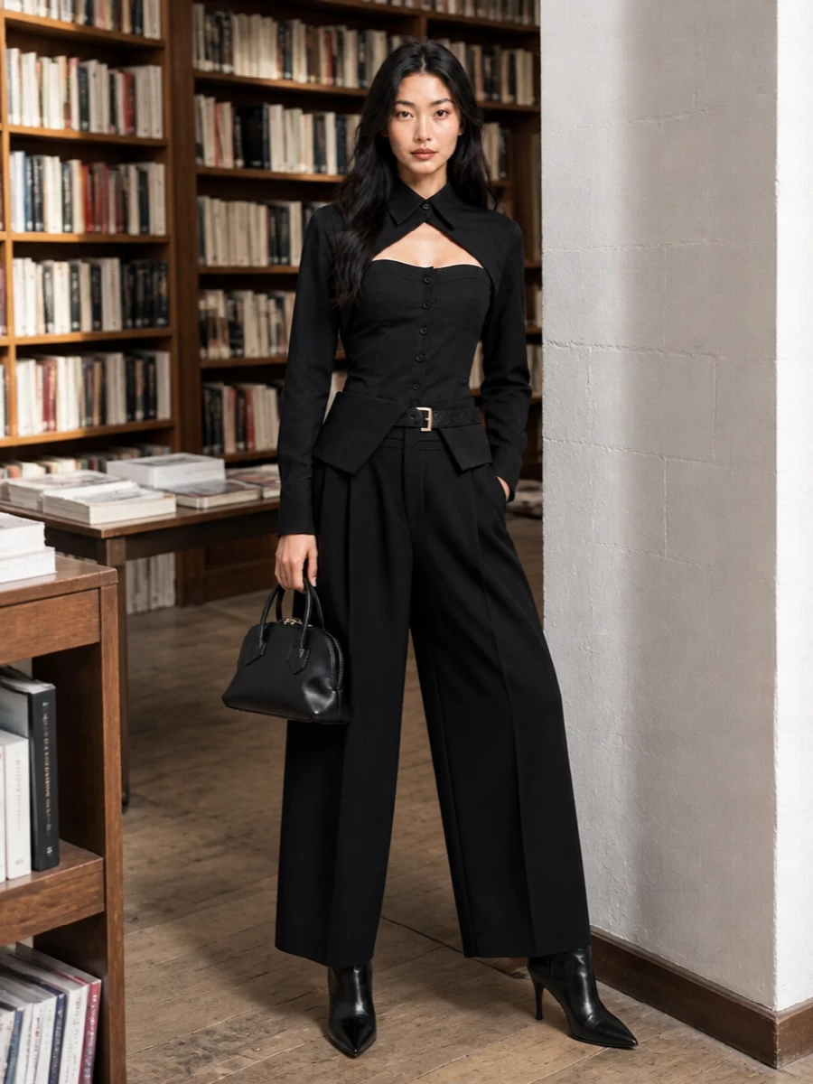 A pure-black Attico ensemble focuses on cut and proportion: a corseted shirt carved into the waist, paired with high-rise belted wide-leg trousers for long, architectural lines. Sleek knee-high boots and a sharp mini top-handle keep the mood strictly nocturnal and polished, while a slim belt quietly draws the eye to the sculpted midsection. The result is a confident, city-night outfit that feels directional without relying on color or embellishment.