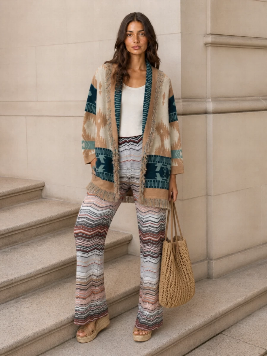 I am skipping a second cardigan or kaftan and building around the Alanui as the sole statement layer, grounded by fluid Missoni chevron trousers so the patterns converse rather than compete. The camel jute wedge and refined open-weave tote keep everything in a sun-bleached neutral story, giving you a quietly luxurious, boho resort ensemble that moves effortlessly from seaside lunch to terrace dinner. Add a simple ivory silk tank underneath and let the knit textures, not extra prints, do the talking.