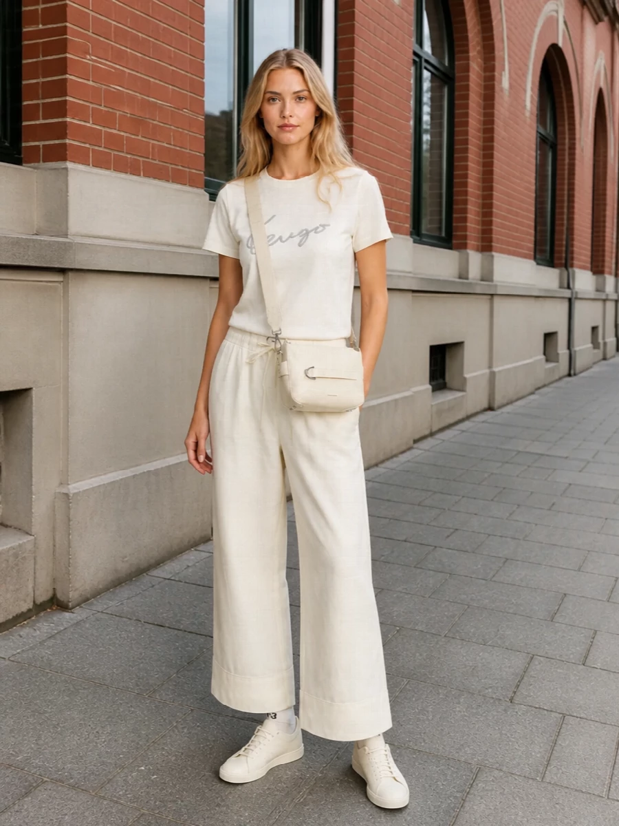Head-to-toe butter tones keep this Kenzo tee outfit calm and graphic, with the wide-leg trouser giving a soft, modern line. Creamy Y-3 sneakers and a structured neutral crossbody keep it grounded in streetwear but quietly polished for city days. It is an easy monochrome uniform that feels considered without ever trying too hard.