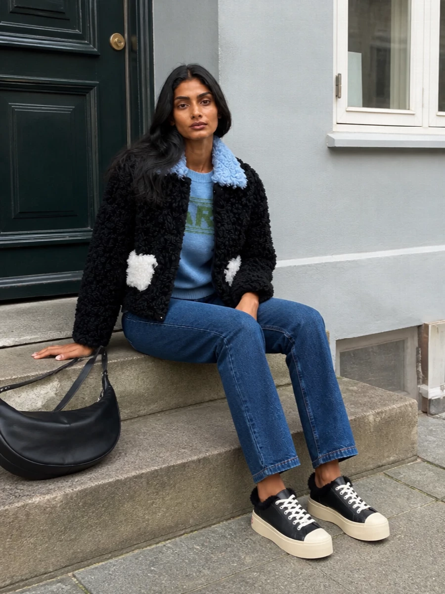 Marni shearling jacket blue knit jeans outfit