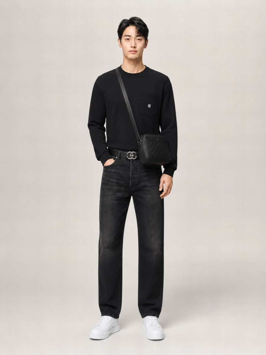 A monochrome Celine story built around the black crewneck and washed-black straight denim, this outfit reads composed and urban without feeling stiff. Optic-white court sneakers break the darkness cleanly, picking up the small logo hit and adding just enough contrast. The structured embossed crossbody and slim Triomphe belt keep everything precise, so it works as easily for a day in the city as for checked-in, carry-on travel.