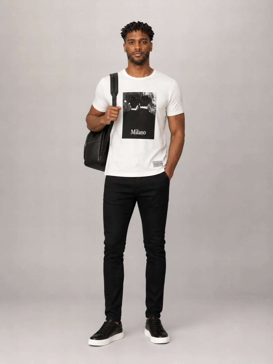 Monochrome and sharp, this outfit leans into Italian street-luxe with a graphic tee grounded by sleek black slim trousers. The clean leather sneakers and structured backpack keep everything intentional, ideal for city days that move from errands to evening drinks. It is relaxed in comfort but reads distinctly put-together up close.