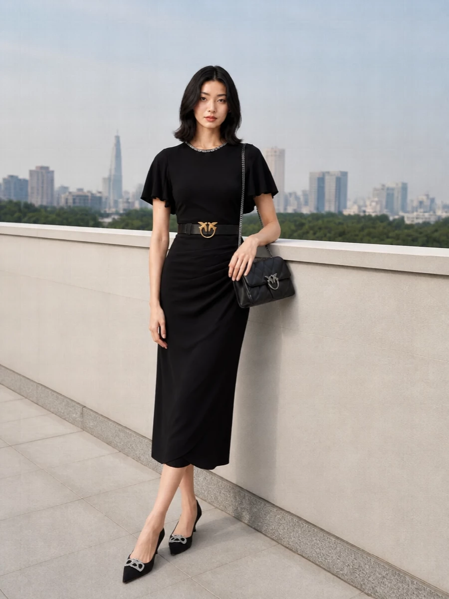 A quietly dramatic black-on-black cocktail pairing, this outfit lets the dress’s soft drape and crystal neckline set the tone. Suede kitten-heel pumps echo the sparkle in a lower, walkable heel, while a quilted black flap bag in silver hardware completes the refined black and silver story. Romantic, fluid and polished, it is made for intimate dinners and elegant drinks in the colder months.