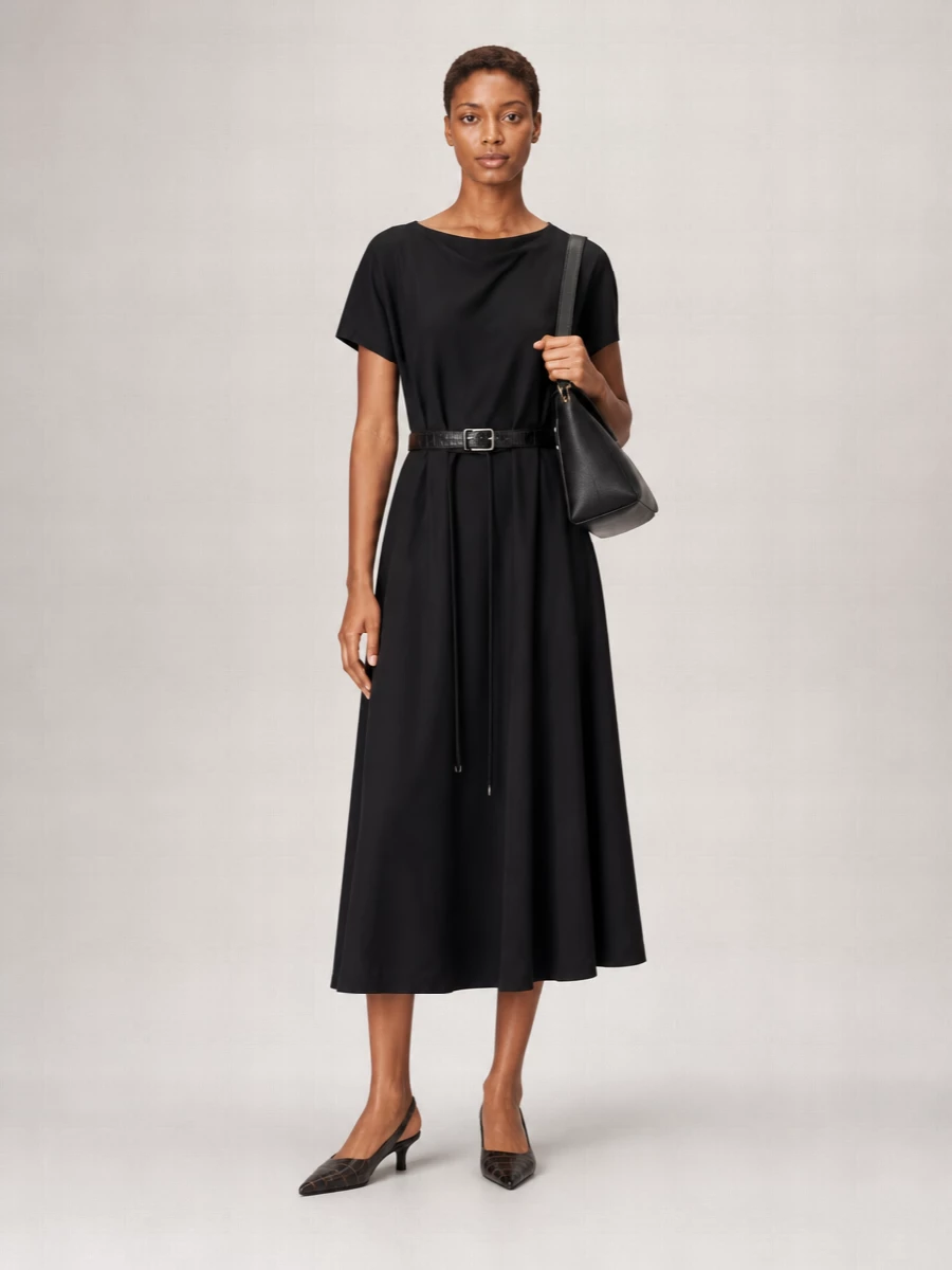 I’m building around the dress rather than separates so the Frankie Shop belt can read as a deliberate, sculpting accent against a single, fluid column of black. The Lemaire midi keeps the mood minimalist and quietly expensive, while croc slingbacks and a structured shoulder bag introduce subtle texture and polish without breaking that calm line. It is an easy city uniform for cooler months, able to move from daytime appointments to discreet dinners with only a jewelry change.