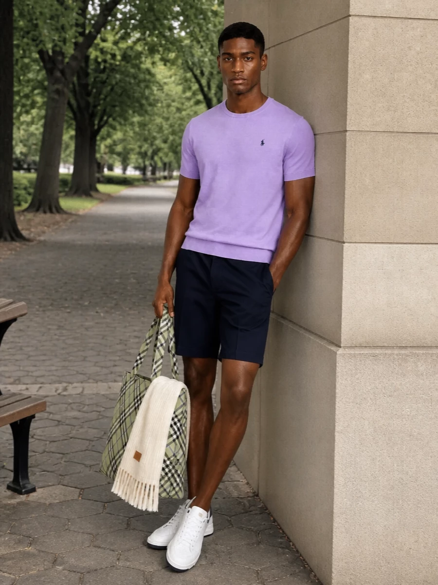 A lavender Polo tee meets clean navy tailored shorts for a fresh, collegiate palette that feels relaxed but intentional. White leather Saint Laurent sneakers and a sage Burberry tote keep the line polished, while cream accessories soften everything into an easy city uniform.
