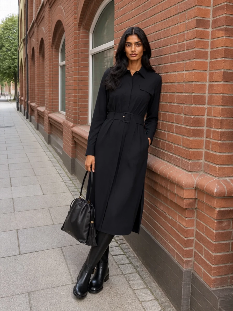I chose the dress path to keep the outfit pared back and columnar, letting the Etro bucket bag’s boho detailing be the quiet focus. The inky Fabiana Filippi shirt dress and polished black riding boots create a long, fluid line in a single dark palette, subtle enough for daytime yet refined for evening. Together they read as relaxed, intelligent luxury with just a hint of Italian romance that sits perfectly beside the bag’s braided tassels and gold logo.