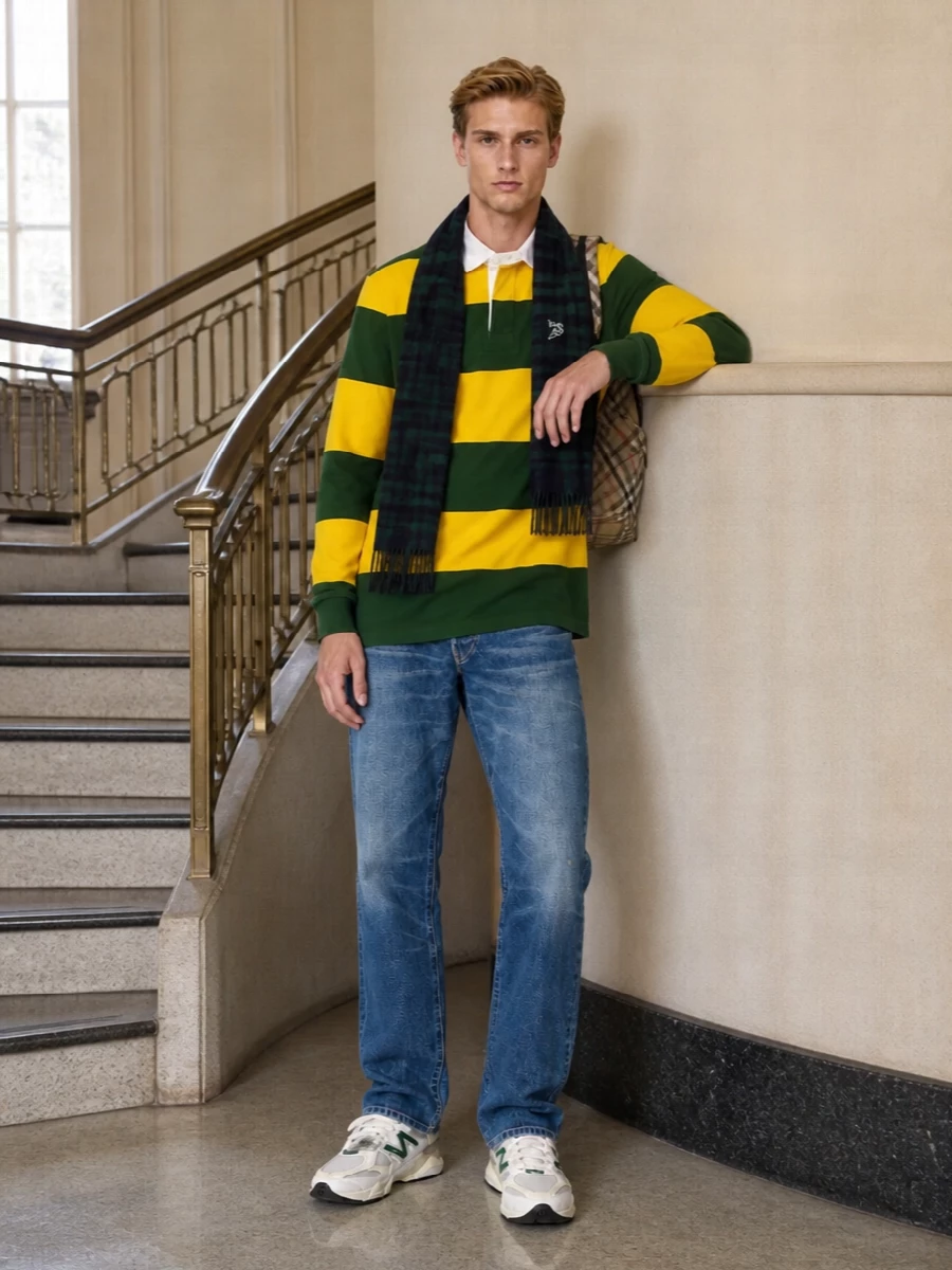 Classic campus energy: the striped rugby sits over broken‑in straight denim, finished with varsity‑leaning runners in matching yellow and green. The Burberry backpack and moody tartan scarf bring just enough polish while keeping everything weekend‑ready.