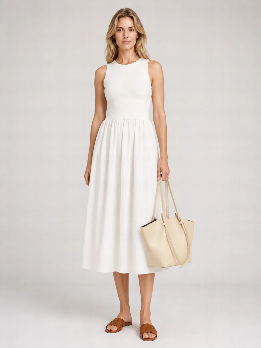I built this around the Staud ivory midi dress, letting its clean high waist and soft volume sit front and center with the cognac Saint Laurent slides for an unfussy, polished summer silhouette. The gathered skirt balances the flat woven sandal so you stay comfortable, while the warm leather grounds all the light ivory tones instead of competing with them. The sculpted buttercream Yuzefi tote continues that neutral story, adding quiet structure and day-ready practicality without breaking the minimalist line.