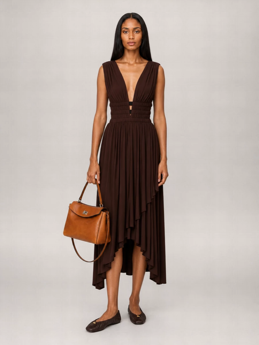 The chocolate Alaïa midi paired with the tan Balenciaga top-handle bag creates a rich, tonal palette that feels quietly confident for dinners, galleries, or a refined date night. Choosing the dress route instead of tailoring keeps the silhouette fluid and sensual while still reading polished. Deep brown ballet flats keep the mood relaxed but intentional, for a minimalist take on evening that does not rely on heels.