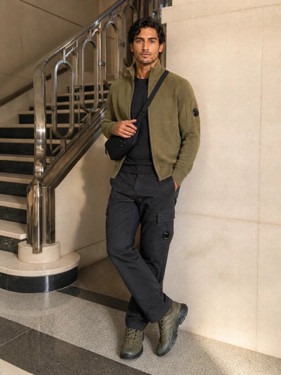 Olive utility on top, charcoal beneath, this is a precise C.P. Company uniform for cold city days. The technical runner and padded crossbody keep it firmly in streetwear territory, but the cleaner lines and darker base make it feel more considered than loungewear. Wear it for days that move between errands, desk and low-key evenings without needing to change.