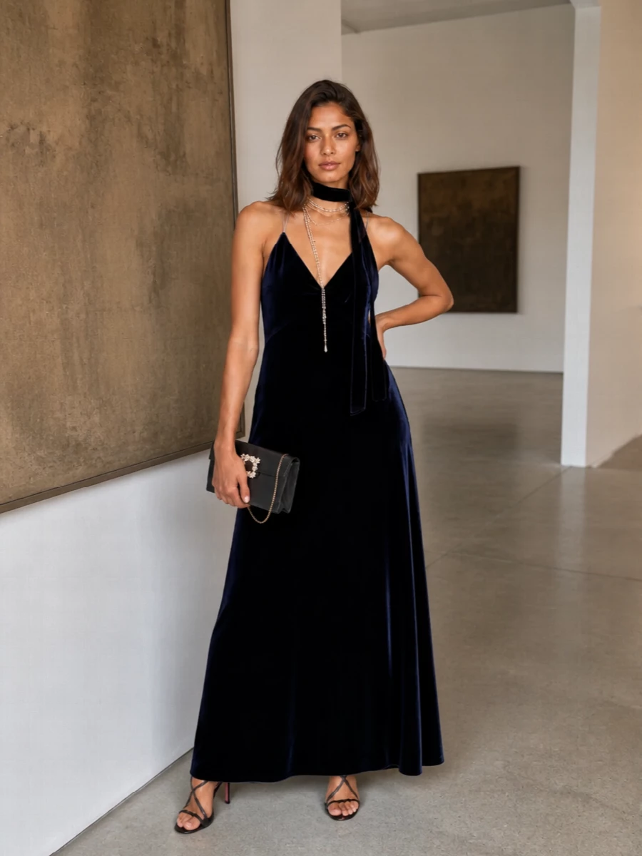 Midnight velvet, black satin and scattered crystal create a quietly dramatic gala ensemble that feels opulent without shouting. Burgundy, pearls and blush are kept out of the core pieces so the gown’s inky depth stays uninterrupted, with jewelry and hardware offering just enough light at the neckline and in the hand.