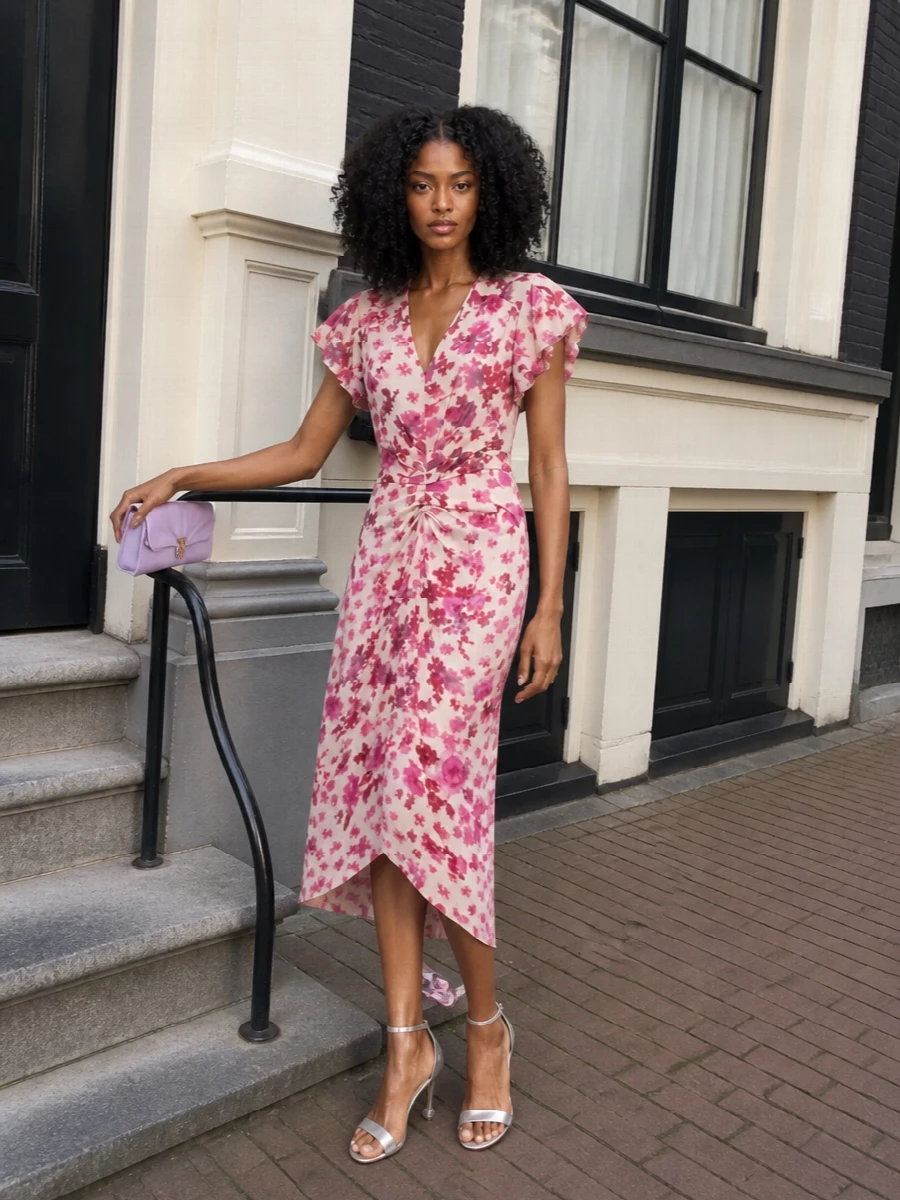 A garden-party romantic mood, with the floral Isabel Marant dress floating around the body and subtle ruching defining the waist. Silver and lilac Roger Vivier accents pick up the pink tones without crowding them, keeping the whole outfit polished enough for weddings and summer evenings while still feeling soft and dreamy.