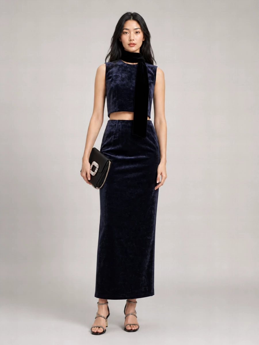 Midnight navy velvet is kept sharp and modern with barely there Fendi straps and a compact black jeweled shoulder bag. The mood is formal, pared back and precise, all about line and texture rather than overt ornament. A single velvet scarf adds a soft, romantic note while staying firmly in the quiet luxury lane.