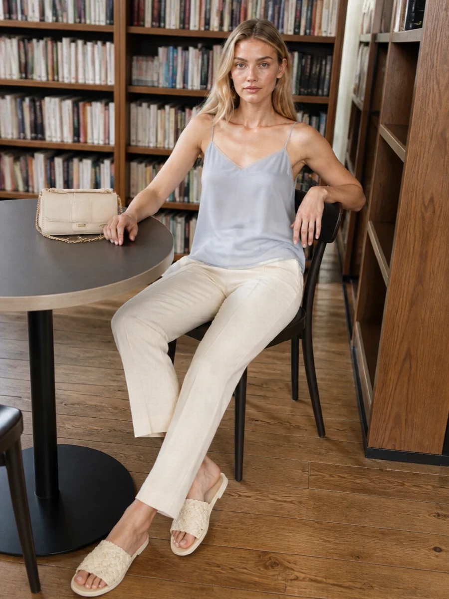 Soft slate blue and buttercream neutrals create a calm, modern palette that feels right for warm city days and low-key dinners. The fluid cami and straight trouser keep the silhouette long and unfussy, while cream accessories stay in the same quiet register. It is refined without tipping into formality, ideal when you want to feel considered but relaxed.