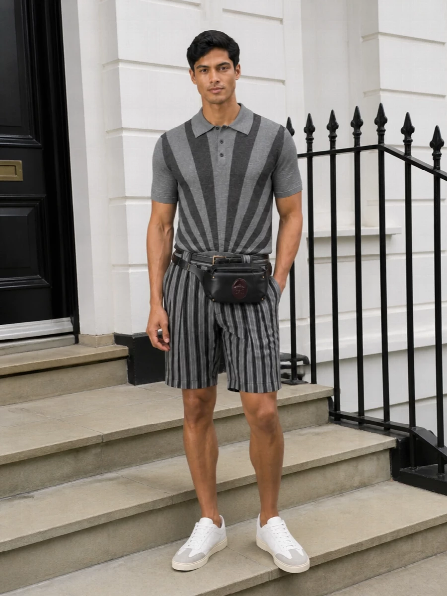 Graphic greys stay the story, with the sunburst knit meeting tailored striped shorts for a sharp, modern take on city summer dressing. Soft neutral sneakers and a compact leather belt bag keep the silhouette clean and streamlined, while discreet gold hardware adds just a touch of Versace glamour. It is relaxed enough for daytime but polished enough to carry you straight into dinner reservations.