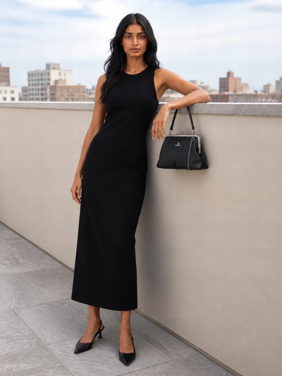 The Totême black column dress with the Vivienne Westwood frame tote creates a quietly assertive evening ensemble, all clean lines and rich texture. Gianvito Rossi’s pointed kitten slingbacks keep the profile sharp yet wearable, letting the silver hardware on the bag and the dress’s cut do the talking. I chose the single dress route over separates to maintain an unbroken black column that best showcases the mini frame tote’s sculptural shape and sophistication.
