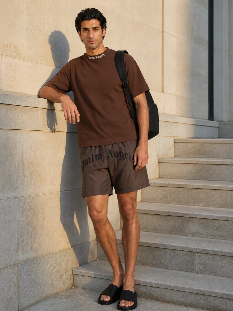 A tonal Palm Angels story built around earthy shorts and a rich brown tee keeps the branding confident but controlled. Black slides and a matching logo backpack tighten everything into a clean, city-ready pool-to-street uniform. It feels relaxed and graphic without tipping into shouty contrast, ideal for warm days on the move.