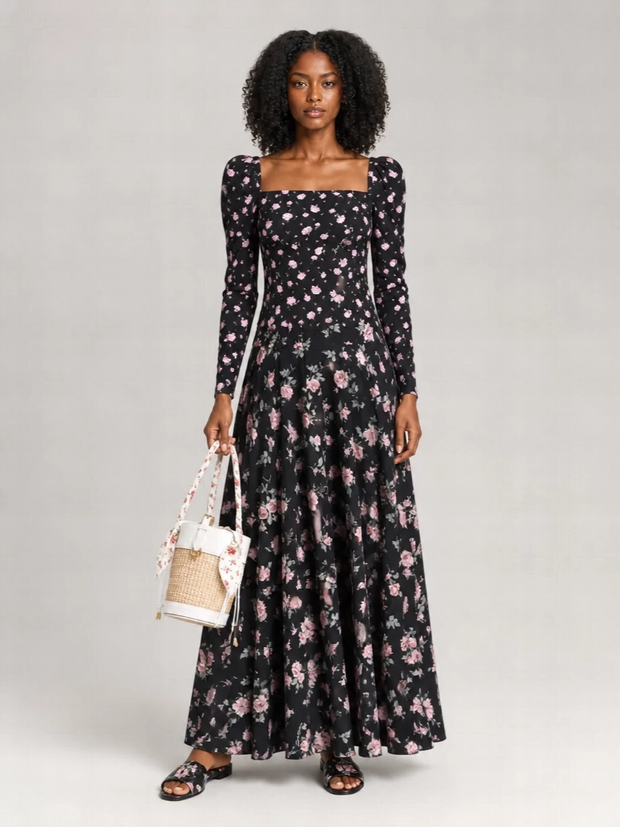 Dolce&Gabbana’s black floral maxi skirt meets its match with the sculpted square‑neck floral blouse, creating a romantic, rose‑strewn column of print that still feels refined. Flat floral slides keep the mood relaxed yet intentional, while the raffia bucket bag and silk scarf introduce light, summery texture so it works as beautifully on sunlit terraces as at candlelit garden dinners.