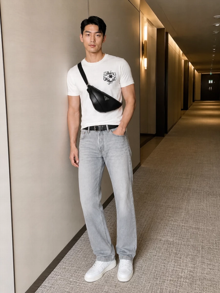Soft white Amiri jersey meets washed grey straight-leg denim for a clean, LA-inflected street uniform that feels relaxed but intentional. Crisp white court sneakers keep the line light and fresh, while a black Prada crossbody and slim belt add just enough structure and contrast without disturbing the monochrome ease.