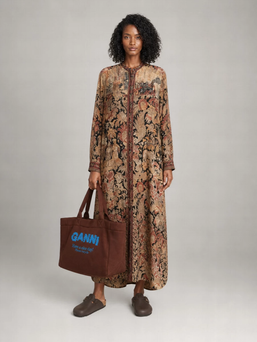The printed shirt dress and chocolate Ganni tote create a softly boho city uniform, all warm browns and tapestry textures that feel collected on travels rather than styled in a hurry. Dark brown clogs keep it grounded and walkable, so it moves easily from market mornings to late café afternoons. Choosing the dress path lets the bag and print conversation stay clean and fluid, instead of breaking the line with denim or tailoring.