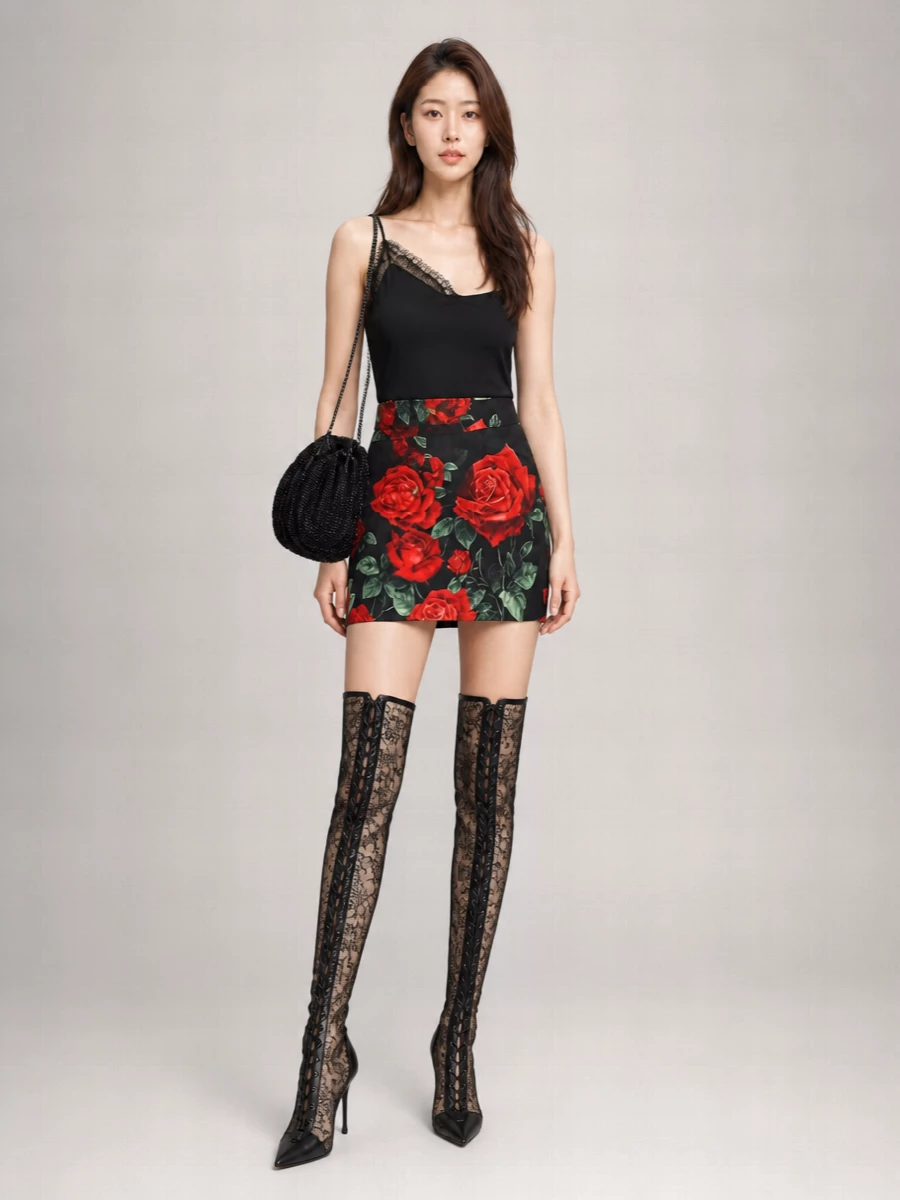 Dolce&Gabbana’s rose mini stays center stage against a pared-back black camisole, letting the print and sheer texture feel unapologetically romantic. Lace-traced knee boots and a beaded shoulder bag echo the sheerness and shine, pulling everything into a cohesive, after-dark floral fantasy. The result is sensual, sculpted and ideal for nights when you want the drama carried in texture and detail rather than color clashes.