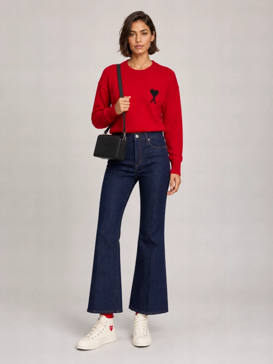 I am building around the socks as a punchy Ami story, so separating top and bottom keeps the proportions relaxed and lets the red run through the outfit without feeling costume-like, which a dress would risk. The red logo sweater, dark flared denim and creamy high-tops frame the socks as a graphic accent, while the black Ami bag grounds everything in an easy, city-ready palette. It is relaxed, logo-forward and quietly coordinated for cool weather days that still feel playful.