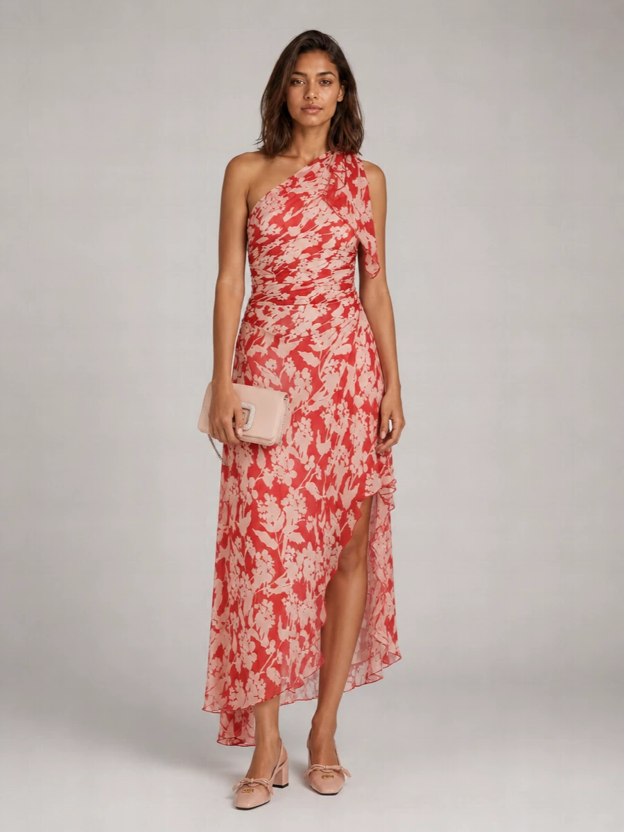 A ruched one-shoulder floral gown in coral and blush is grounded with blush block-heel slingbacks and a crystal-buckled blush clutch for quietly glamorous cocktail dressing. The palette stays in the nude and pink family so the print remains the focus, while subtle sparkle and a soft silk foulard keep the mood romantic rather than ornate. It is polished enough for weddings or summer galas yet feels light and fluid when you move.