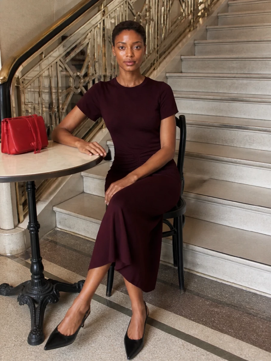A deep burgundy midi grounds the red Celine clutch, letting the bag deliver the colour hit while the silhouette stays clean and restrained. Black slingback heels keep the line sharp and minimal, so the overall feel is polished, modern and quietly confident for autumn evenings. I chose the dress route rather than separates to maintain a single, uninterrupted column of colour that supports the clutch as the focal point.
