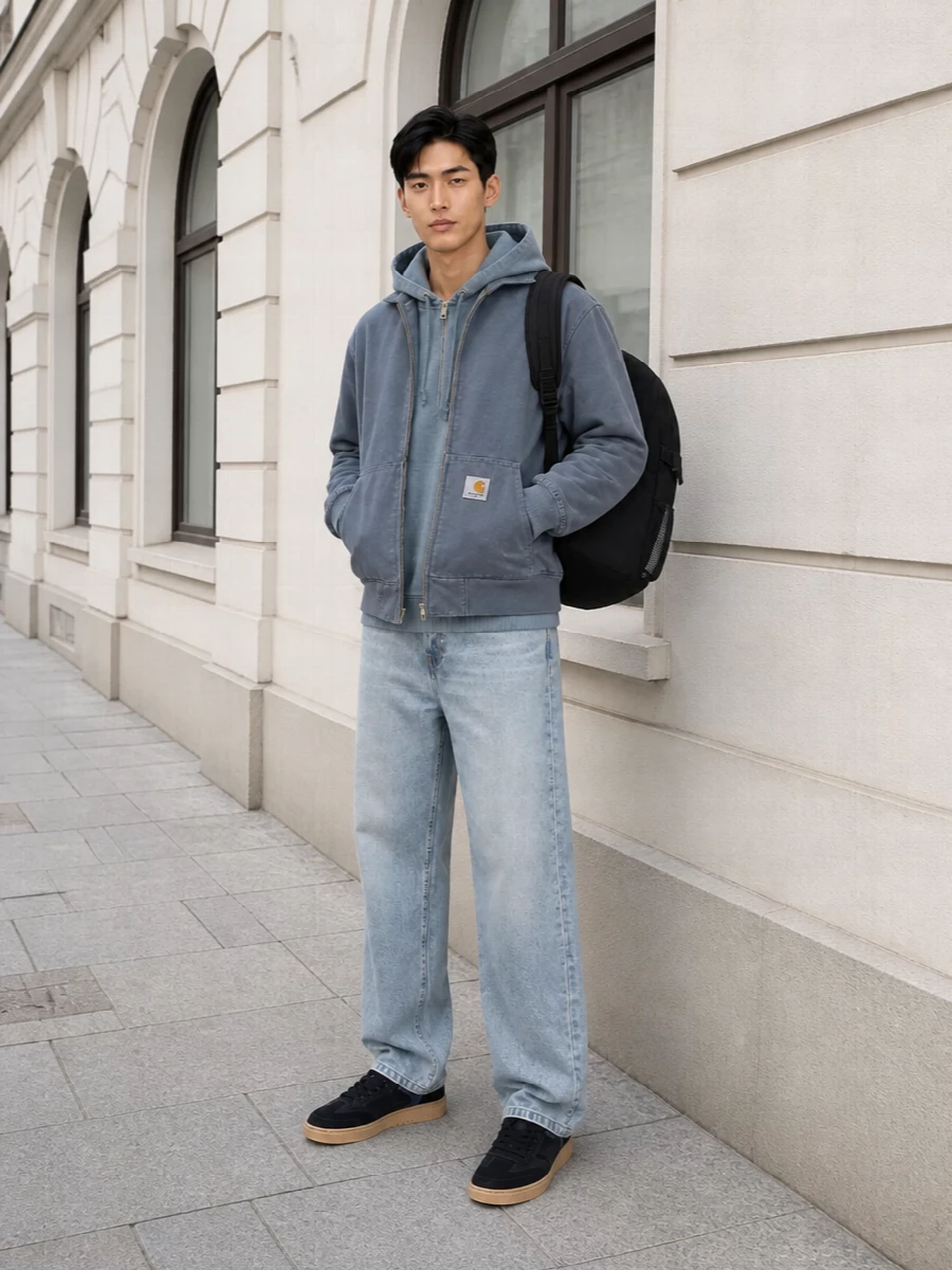 A muted blue-grey story built around Carhartt workwear, grounded with light stonewashed denim for a clean, laid-back street uniform. Black and gum sneakers plus a technical backpack sharpen the palette without breaking the soft, washed vibe. It is an easy city combination that feels sturdy, relaxed and quietly put together from commute to skate spot.
