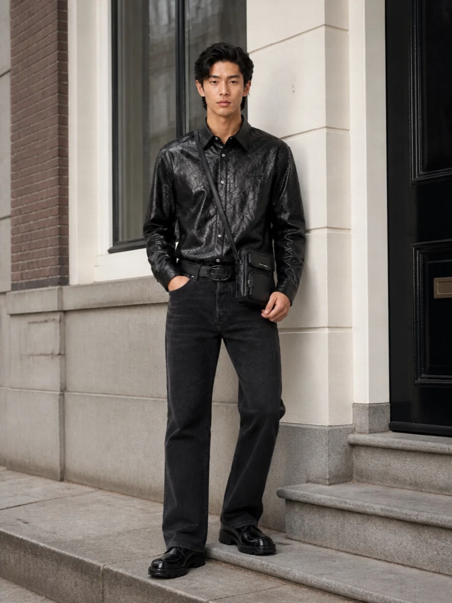 This is a dark, club-ready Diesel ensemble built around high-shine black and faded charcoal. The crinkled shirt and polished derbies carry the drama, while the straight faded jeans and minimal crossbody keep it grounded and wearable. A sleek logo belt pulls the waist in just enough to keep the silhouette clean rather than slouchy.