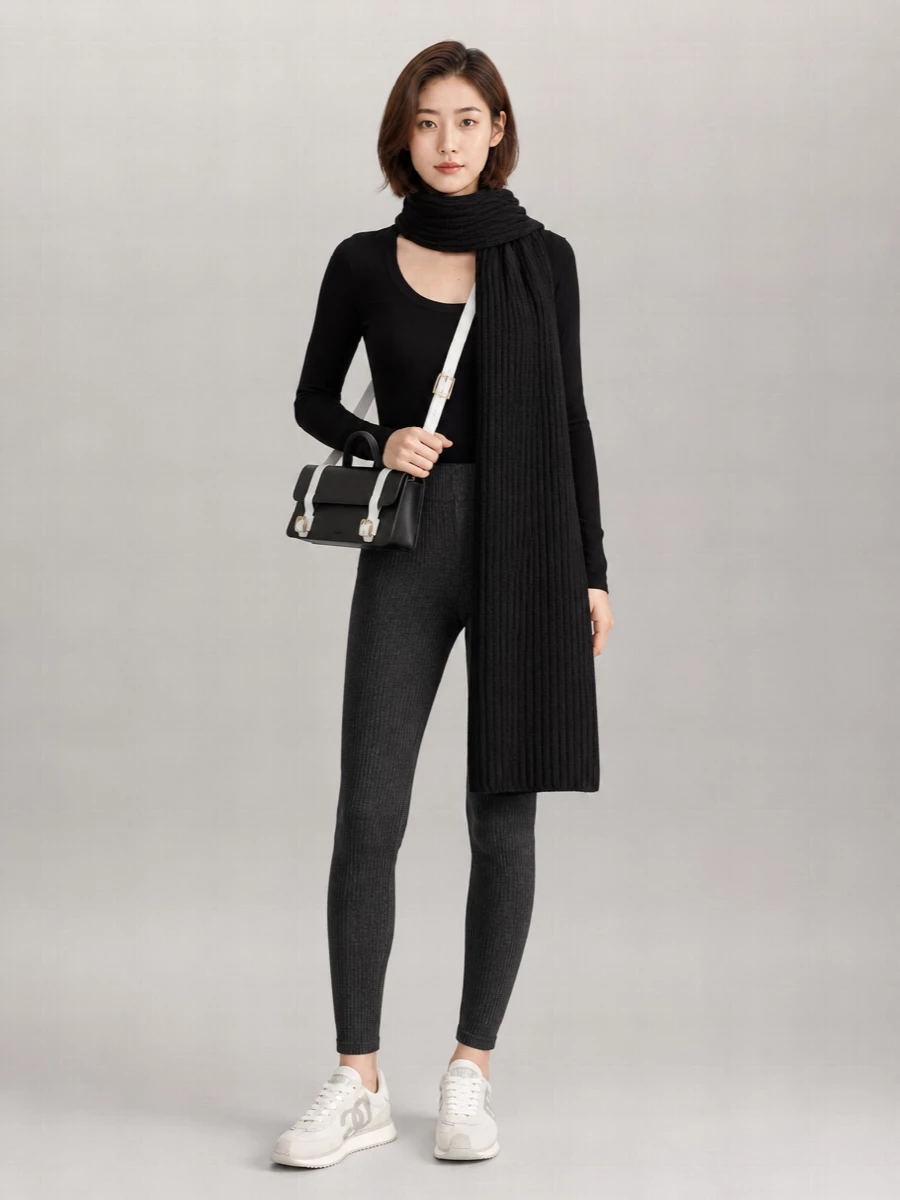 Charcoal ribbed leggings meet a finely cut black scoop-neck knit for a streamlined, second-skin base. Off white retro runners and a structured black-and-white cross-body keep the mood sporty yet refined, with a ribbed scarf adding subtle texture and depth.