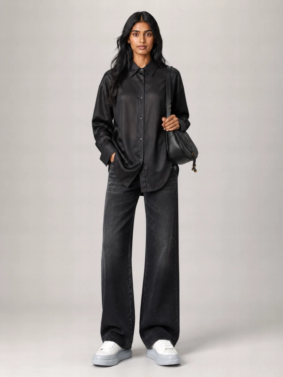Washed-black Gucci denim grounds an all-dark palette, setting a quietly graphic base for Loewe’s fluid black shirt. Alexander McQueen’s sculptural white sneakers lighten the column just enough, while the curved Chloé shoulder bag finishes the mix with pared-back structure. The result is modern, polished streetwear that reads considered without feeling dressed up.