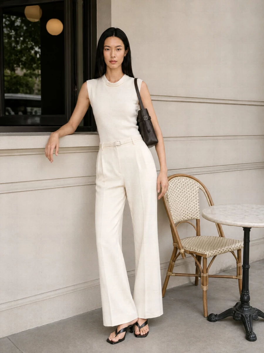 A buttercream column in Totême’s sculpted shell and high-rise wide-leg trouser feels calm, precise and quietly confident for warm-weather office days and understated dinners. Black slingbacks and an espresso structured bag add just enough graphic tension while staying firmly in the minimalist, quiet-luxury space. The tonal belt simply refines the waist, keeping the silhouette long and clean rather than fussy.