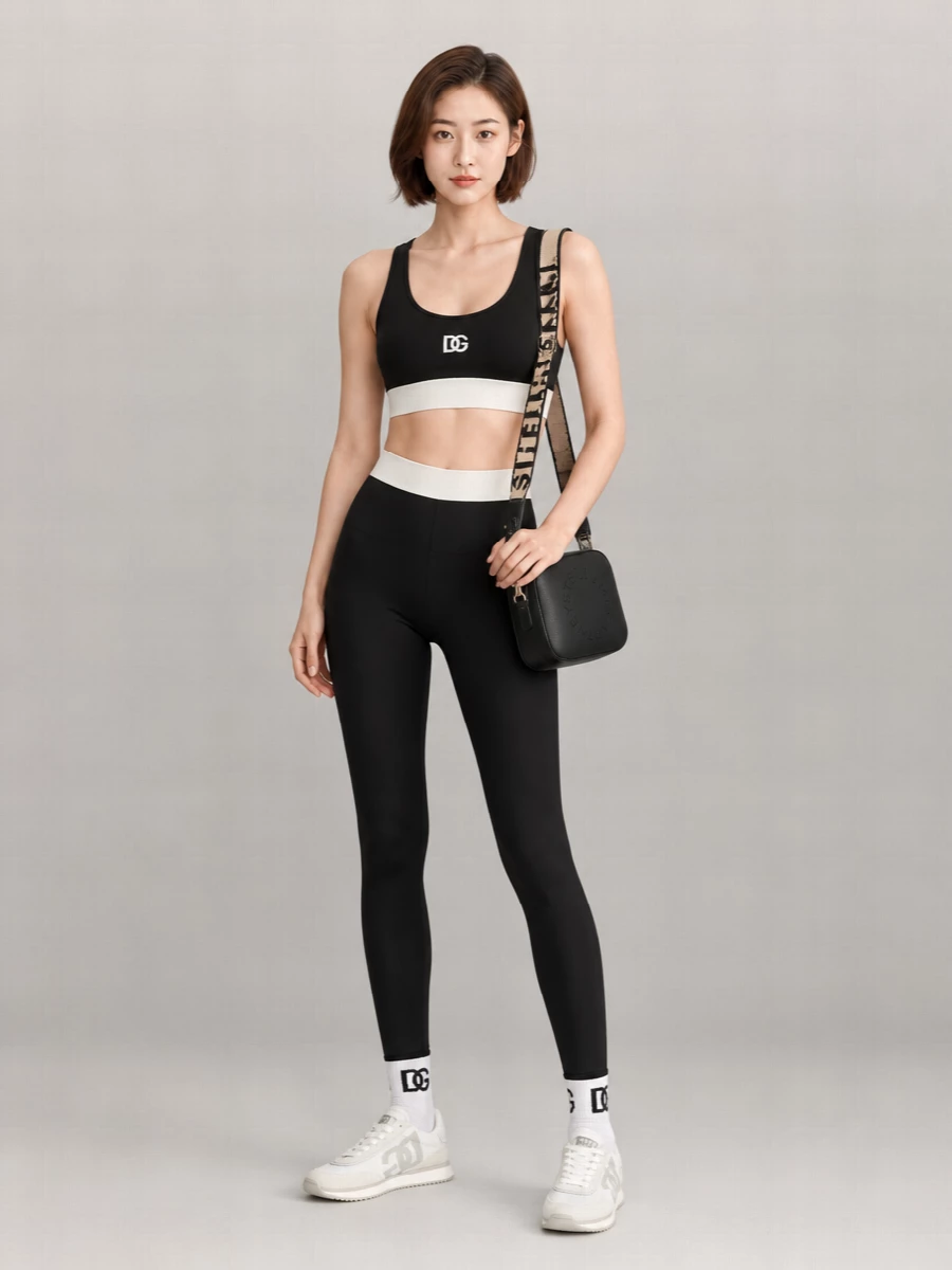 A clean monochrome DG base, with the stretch bralette and high‑rise leggings forming a streamlined, body‑skimming silhouette. Retro runners and a compact crossbody keep it firmly in sporty, city‑ready territory, ideal from errands to travel days. Logo ankle socks are the quiet finishing touch that makes the set feel intentional rather than improvised.