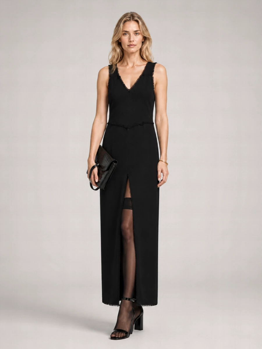 A stark black column, a sculptural heel and a single gold cuff create a precise, quietly sensual evening ensemble. The mix of Totême and Margiela keeps the mood intellectual rather than flashy, all clean lines and subtle texture. Sheer thigh-highs sharpen the slit and turn the dress into a confident, after-dark statement without breaking the minimalist code.